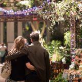 A couple walkin through the Holiday Train Show.