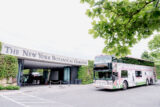 a large double decker bus is parked outside the Main Entrance of NYBG