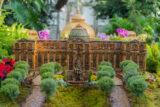 A miniature museum building made of plant parts, with a green dome on top