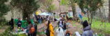 A group of people gathers in a green garden for a celebration