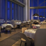 A view of a luxuriously appointed dining room with soft lighting