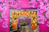 A series of colorful, squared archways in pink, purple, and orange, decorated with hundreds of colorful flowers