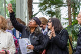 People on a tour listen to a tour guide as they point to an interesting item