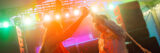 Two people dance under the bright, colorful lights of a dancefloor celebration