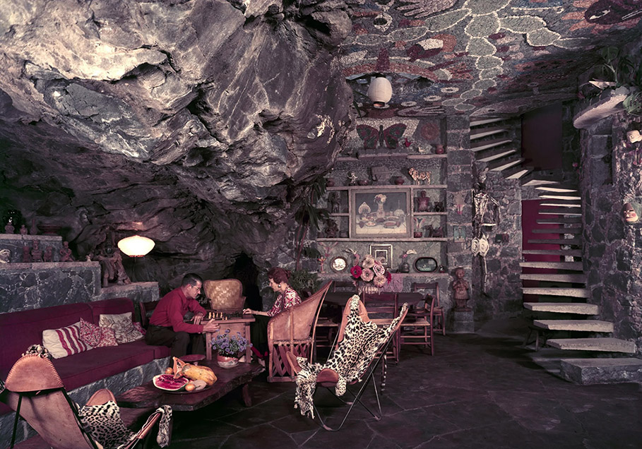 Two people dine inside a lavishly decorated cave