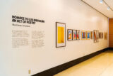 A brightly lit gallery space displaying framed photographs