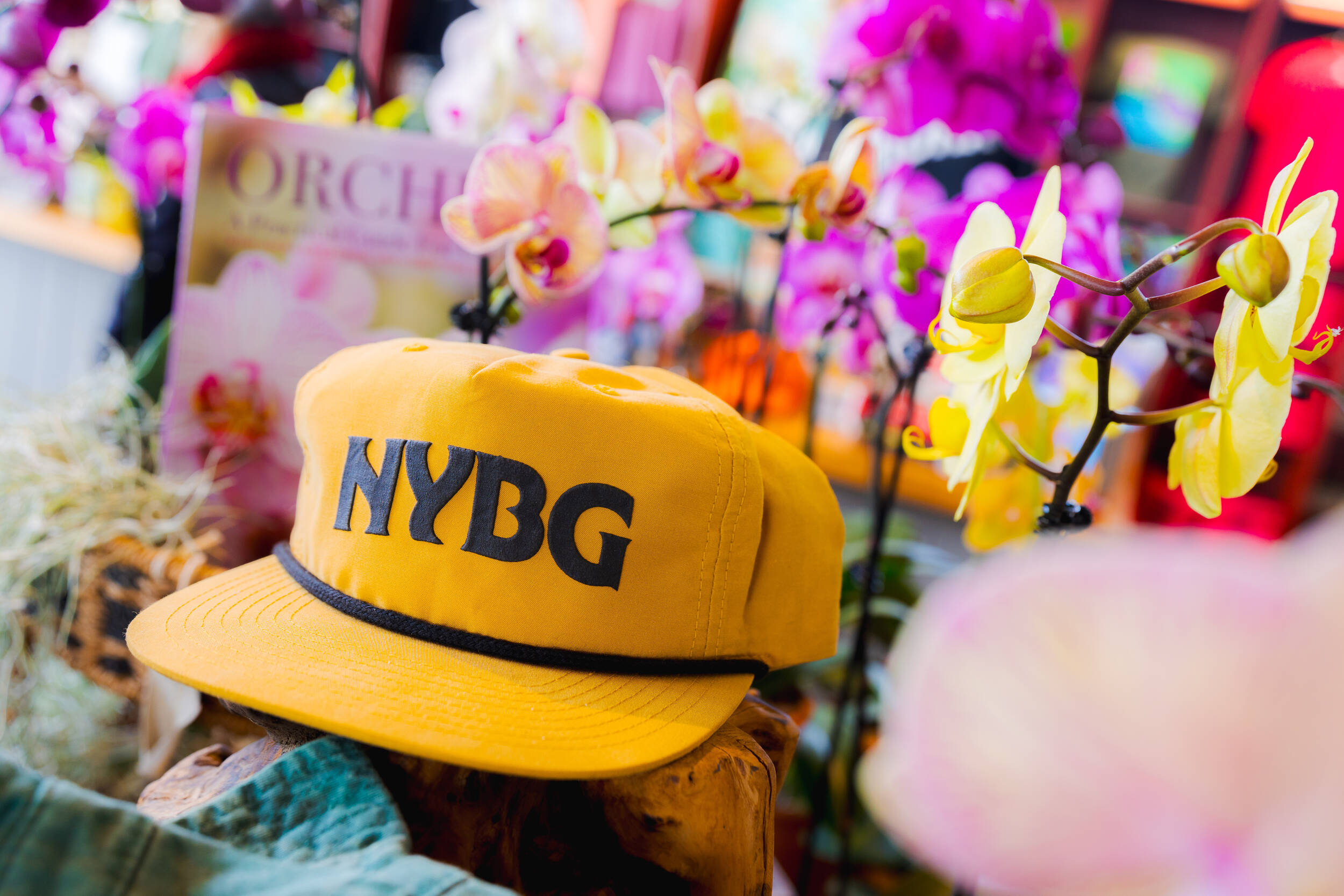 A collection of colorful flowers, gardening merchandise, and hats