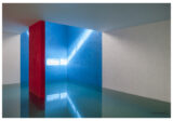 A photograph of an architectural space featuring blue, red, and white paints